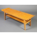 A mid 20th Century rectangular oak and plywood 2 tier coffee table raised on outswept supports