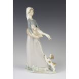 A Lladro figure of a girl holding a goose with a puppy at her feet 4866, 29cm