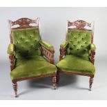 A pair of late Victorian carved oak open arm chairs upholstered in green buttoned Dralon with bobbin