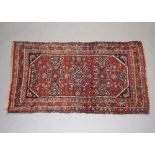 A Persian blue and green ground rug with 3 stylised medallions to the centre within a multi row