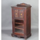 A Victorian inlaid rosewood music cabinet with raised back enclosed by an inlaid and glazed door