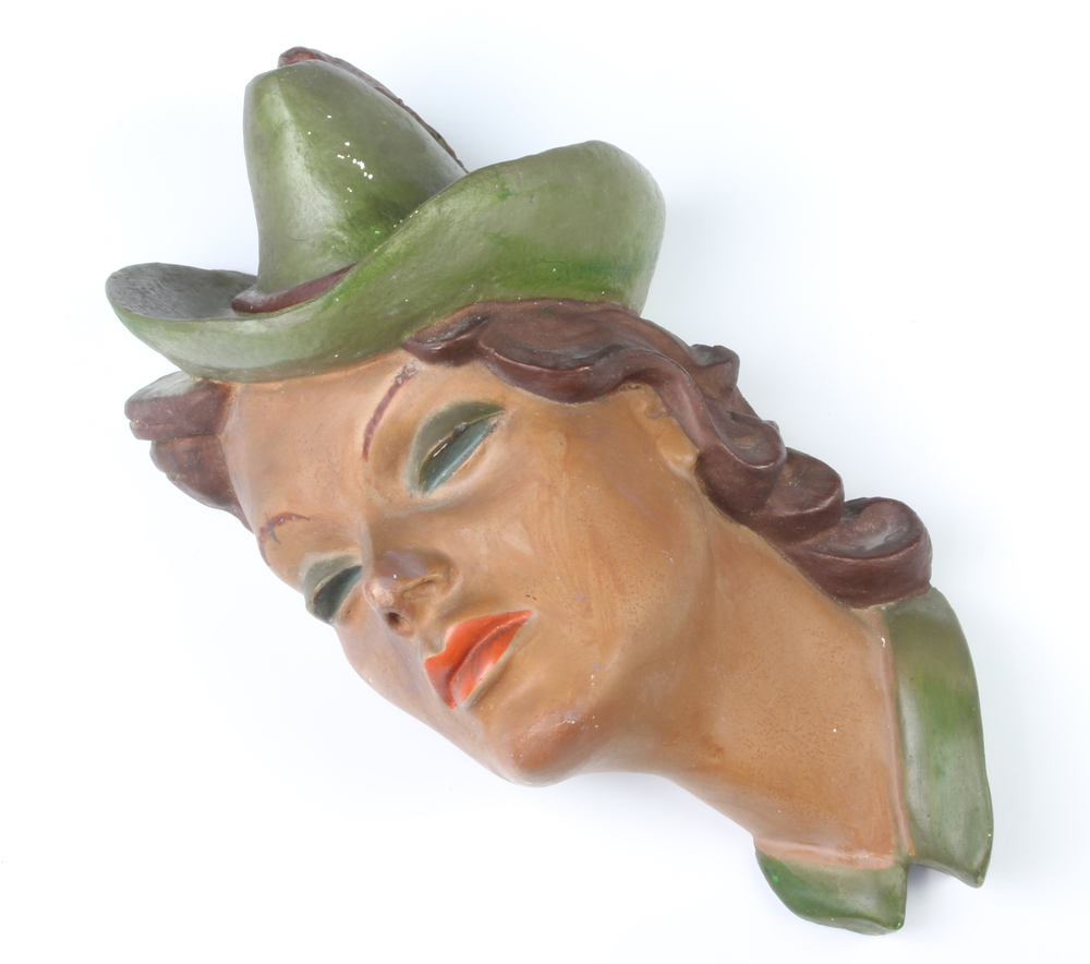 An Art Deco plaster wall mask in the form of a lady wearing a hat, signed B Collin, 30cm