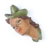 An Art Deco plaster wall mask in the form of a lady wearing a hat, signed B Collin, 30cm