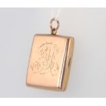 A 9ct yellow gold rectangular locket with engraved monogram, 4 grams