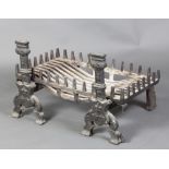 A pair of 19th Century iron fire dogs 48cm x 24cm x 50cm together with an associated basket 15cm x