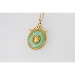 A yellow gold mounted jade pendant and chain