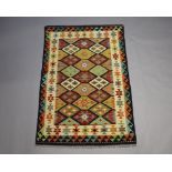 A yellow, turquoise and tan ground Chobi rug with all over geometric design 186cm x 124cm