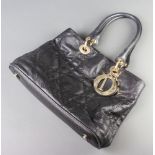 Christian Dior, a black quilted fabric handbag, having a black interior labelled Christian Dior,