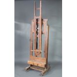 A 19th Century oak adjustable artists easel with ratchett, approx. height 244cm x 72cm w x 65c