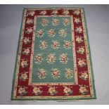 A green and red ground floral patterned kilim rug 262cm x 175cm This rug has an aroma and requires