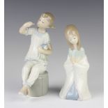 A Lladro figure of a kneeling girl 15cm, ditto of a girl sitting on a pouffe holding a doll 17cm