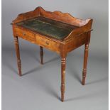 A Victorian mahogany writing table with 3/4 gallery, inset leather writing surface and 2 drawers,