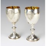 Two Edwardian silver presentation cups with applied armorial decoration, London 1904 and 1906, 305