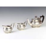 A silver 3 piece demi-fluted tea set with ebony mounts, Sheffield 1925, maker Mappin and Webb, gross