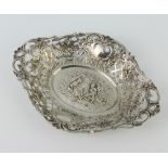A Continental 800 standard shaped repousse dish decorated with fete gallant scene surrounded by
