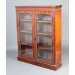 A Victorian mahogany bookcase/display cabinet with fluted cornice, fitted shelves enclosed by arched