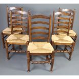 A set of 5 elm ladder back dining chairs with drop in woven rush seats, raised on turned supports