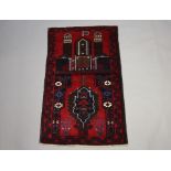 A Belouche pictorial rug decorated buildings 141cm x 85cm