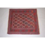 A red and blue ground Gazak rug with diamond medallions to the centre within a multi row border