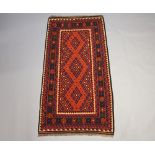 A black and blue ground Ghalmori Kilim with central field within a multi row border 210cm x 107cm