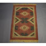 A pink and blue ground Kilim with geometric designs to the centre 177cm x 114cm This rug has an