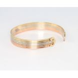 A 9ct 3 colour gold torque bangle, 12.3 grams