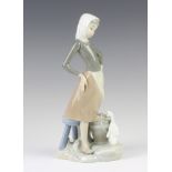 A Lladro figure of a girl with a bucket of water and a goose at her feet, 23 cm