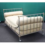 A 19th/20th Century American polished steel and brass campaign bed complete with mattress and 2