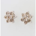 A pair of 18ct white gold 7 stone daisy ear studs, approx. 1ct, 8mm