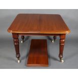 A Victorian mahogany extending dining table raised on turned and fluted supports with 1 extra leaf