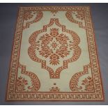 A Patrick Fryer Collection machine made cream and orange ground rug with central medallion 170cm x