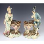 A pair of Continental Majolica figures with lady and gentleman chess players raised on rococo