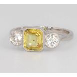 A platinum yellow sapphire and diamond ring, the centre cushion cut stone 1.5ct, the 2 brilliant cut