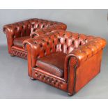 A pair of Chesterfield style armchairs upholstered in light brown buttoned leather This is some