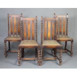 A set of 4 1930's oak stick and rail back dining chairs with upholstered drop in seats raised on