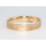 A 9ct yellow gold engraved bangle, 14.3 grams