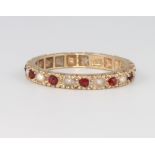 A 9ct yellow gold ruby and pearl eternity ring size L, 1.9 grams
