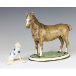 A 19th Century Staffordshire figure of a horse on an oval base 19cm and a ditto of a pug dog on a