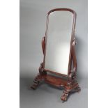 A Victorian mahogany arched shaped plate cheval mirror contained in a swing frame, the base of