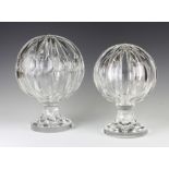Two faceted glass round spheres on round bases 32cm and 29cm