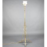 A Victorian wrought brass standard oil lamp on a cruciform base converted to electricity 166cm h