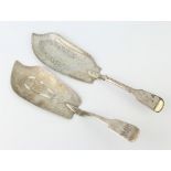 A George IV silver fiddle pattern fish slice engraved with a fish together with a Georgian ditto