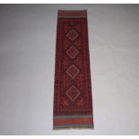 A red and blue ground Meshwani runner with 4 diamonds to the centre within a multi row border