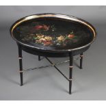 A 19th Century style oval papier mache occasional table raised on faux bamboo supports with X framed