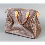 Louis Vuitton, a lady's canvas handbag complete with padlock and key and leather handles,