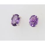 A pair of silver and amethyst ear studs