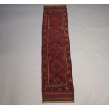 A red and blue ground Meshwani runner with 4 diamonds to the centre within a multi row border