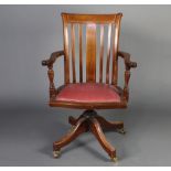 An Edwardian inlaid mahogany stick and bar back revolving office chairSome contact marks in places