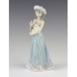 A Lladro figure of a girl holding a puppy 5645, 21cm