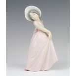 A Lladro figure of a girl wearing a bonnet 19cm